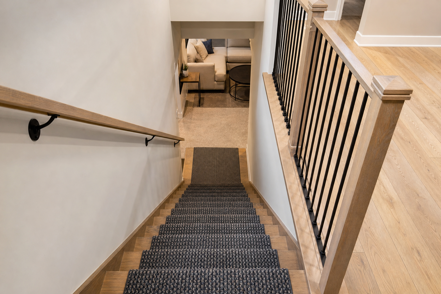 Finished staircase with a runner leading to a carpeted basement