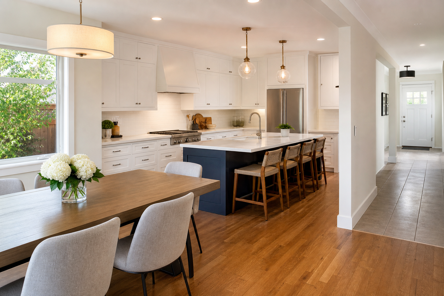 Finished kitchen and dining area with hardwood floors and adjacent tile wet-zone