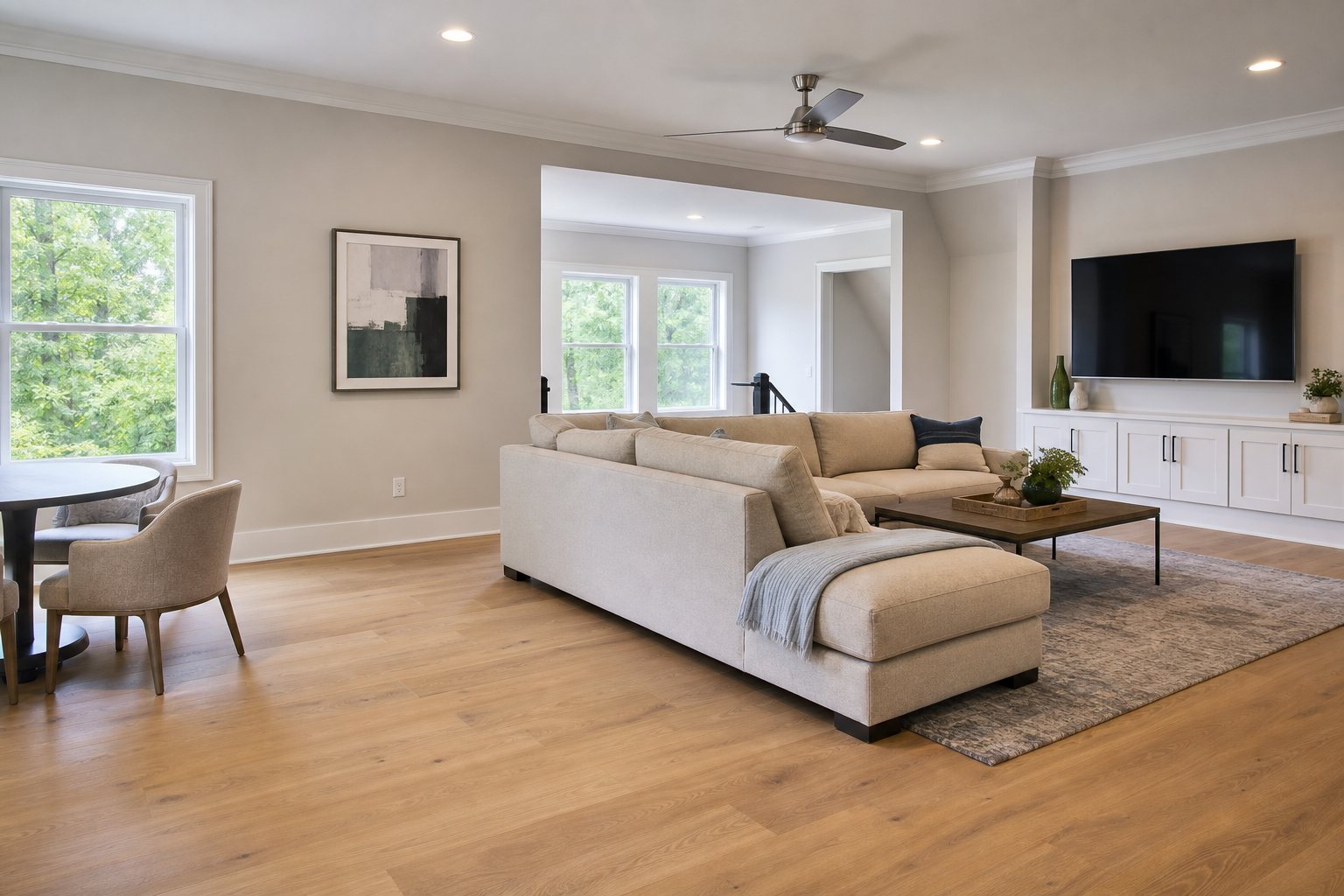 Finished bonus room with wide-plank engineered hardwood and warm natural light